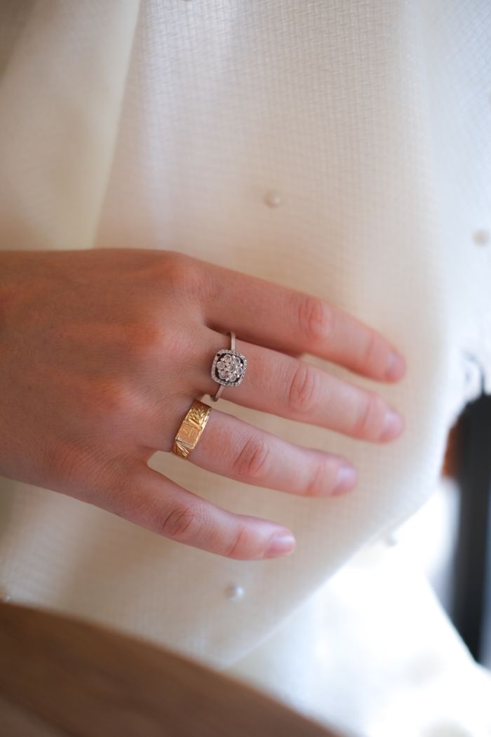 Close-up of an elegant hand adorned with diamond and gold rings, showcasing style and sophistication.